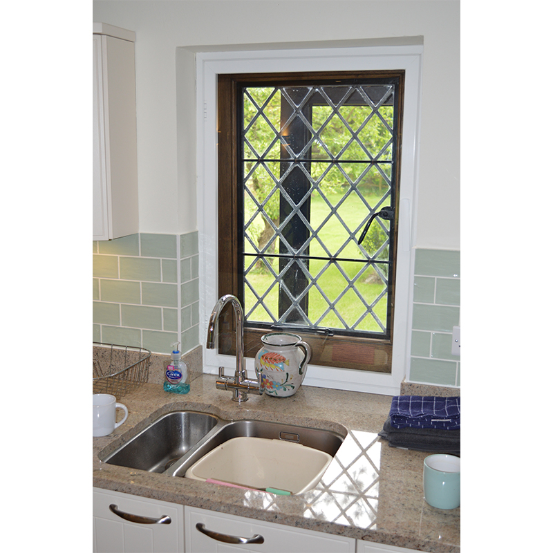 Entrance lodge kitchen window with a secondary glazed inward opening casement