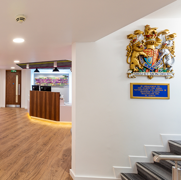 Selectaglaze reception area in St Albans head office with Royal Crest on the wall